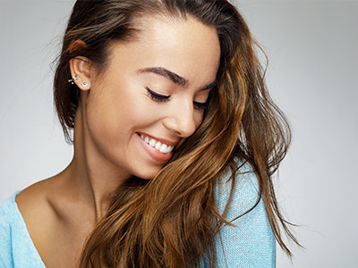 A woman with long hair smiling at the camera.